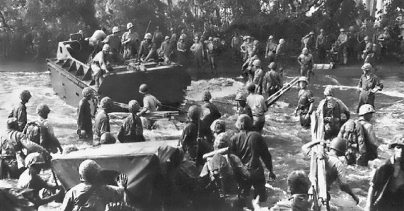 Moving off the ramp of a Coast Guard-manned landing craft