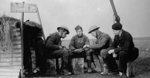 Army and French Air Force personnel outside a dugout named ’10 Downing Street’ on the edge of an airfield, 28 November 1939.