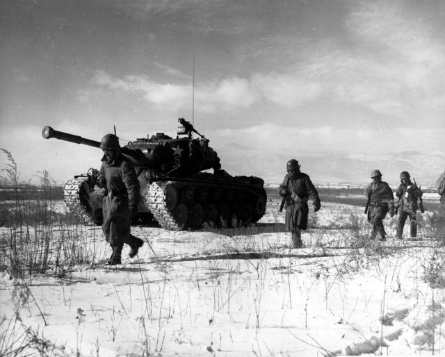 A column of troops and armor of the 1st Marine Division move through communist Chinese lines during their successful breakout from the Chosin Reservoir in North Korea. The Marines were besieged when the Chinese entered the Korean War November 27, 1950, by sending 200,000 shock troops against Allied forces.