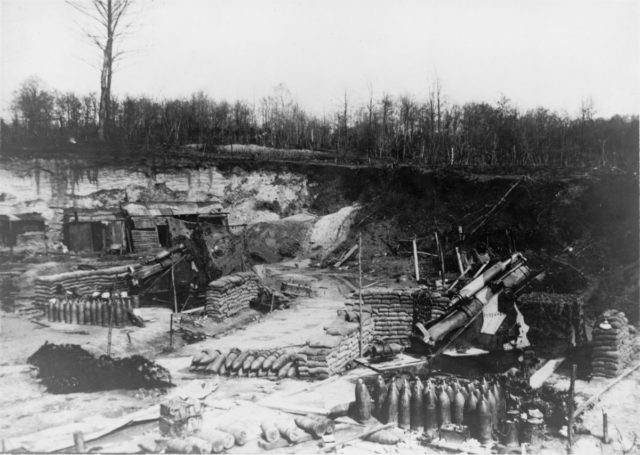 Photograph showing two camouflaged BL 9.2 inch howitzers. Nearest gun is named "Persuader". The guns' recoil buffers are disconnected. This is believed to be a German photograph of abandoned British guns captured during the Spring Offensive of March 1918.