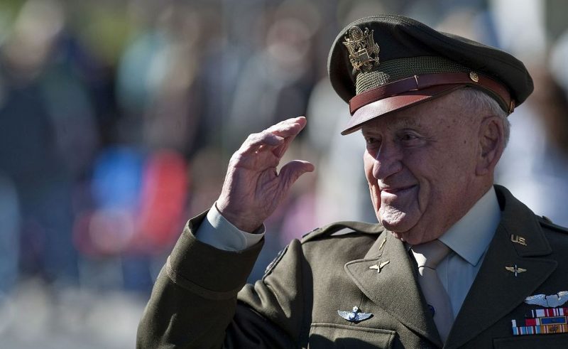 World War II fighter pilot and US veteran, salutes the crowd during a Veterans Day Parade. Wikipedia / Public Domain