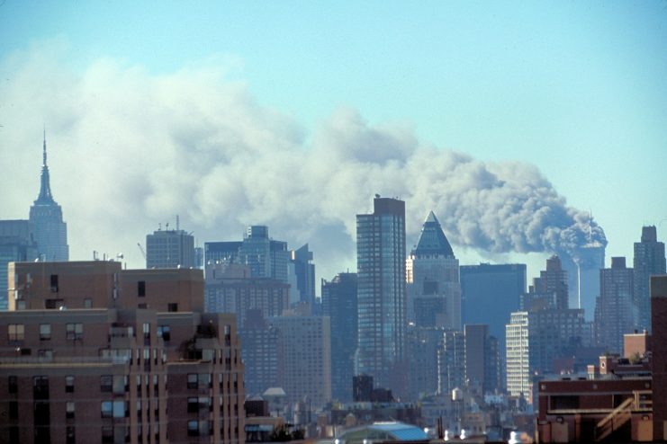 Skyline of Manhattan with smoke billowing from the Twin Towers following September 11th terrorist attack on World Trade Center, New York City. Sept. 11, 2001.
