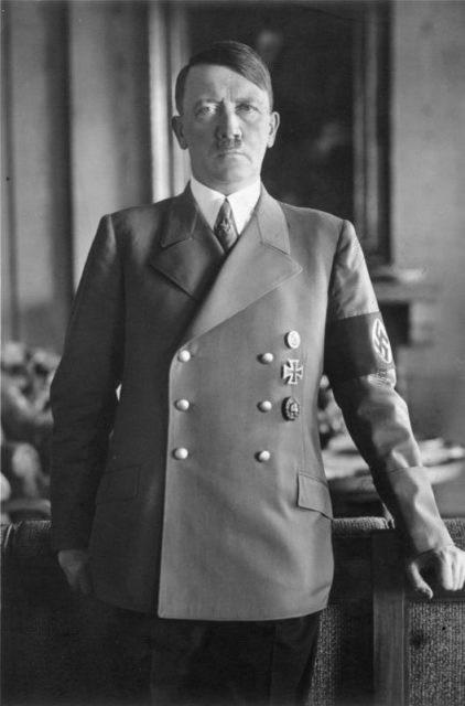 Adolf Hitler poses for a photo in 1938. By Bundesarchiv – CC BY-SA 3.0 de