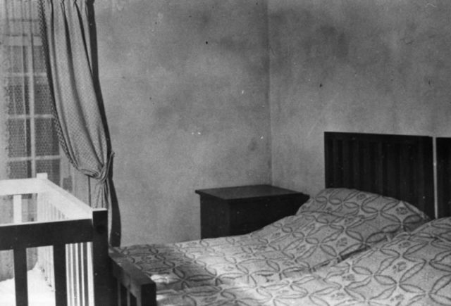 A completely furnished bedroom in one of the interiors of the German village. U.S. Army/Wikipedia/Public Domain.