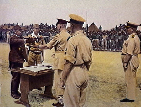 Wewak, 1945-09-13. Major-General HCH Robertson, GOC of the Australian 6th Division, at the ceremony at which the commander of the 18th Japanese Army in New Guinea, Lieutenant-General Hatazo Adachi, signed the surrender document, accepting from general Adachi his sword, symbol of the defeat of the Japanese.