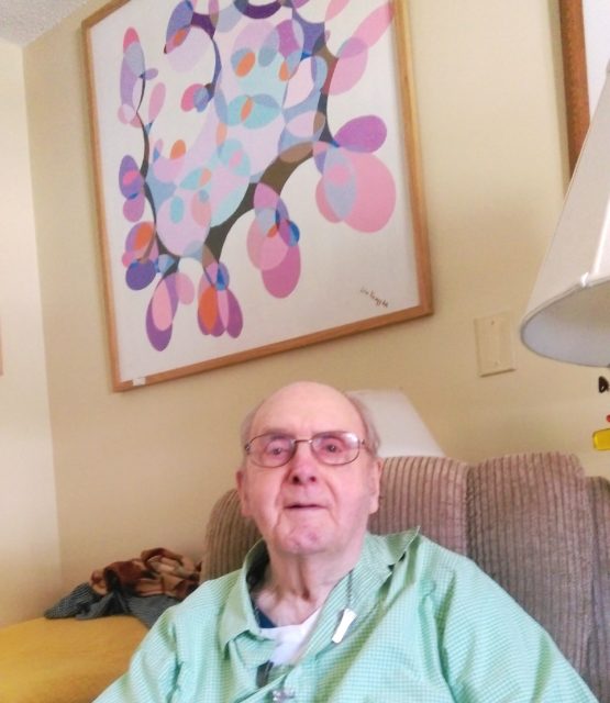 World War II veteran E. John Knapp is pictured with one of the many paintings he has completed over the years. The former navigator has also penned the story of this wartime service at the urging of his children. Courtesy of Jeremy P. Amick.