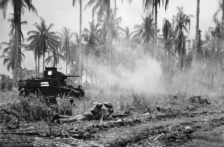  Australian-Manned General Stuart M3 Light Tanks Bust Japanese Pillboxes In The Final Assault On Buna Members Of D Company, 2 / 12Th Battalion, Await The Order To Move Forward After The Tank Has Finished Its Task Crouching Nearest The Tank Is Company Sergeant Major McCominski, and in the foreground Private M Daniels.
