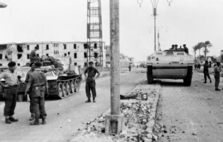 British Paras and Marines at the Coast Guard barracks, next to a captured SU-100 on the left. 