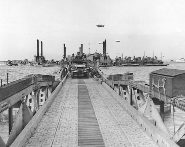 A Whale floating roadway leading to a Spud pier at Mulberry A off Omaha Beach.