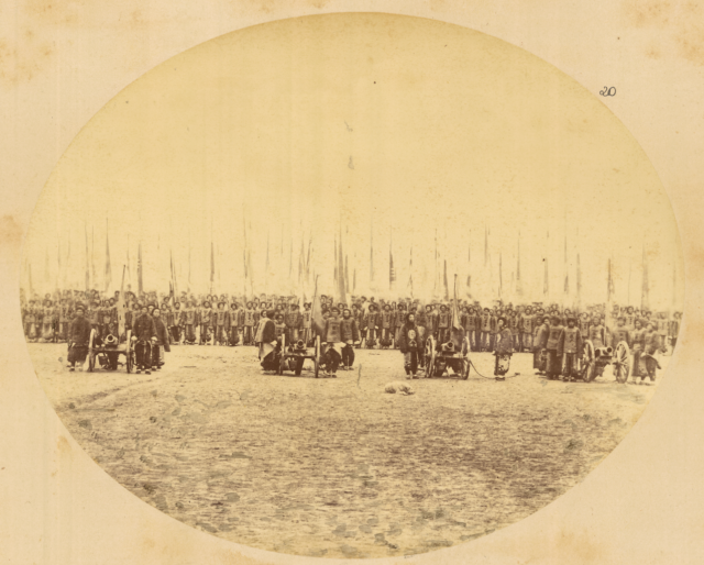 troops_carrying_flags_in_military_formation_preceded_by_four_cannons-_gansu_province_china_1875_wdl1912