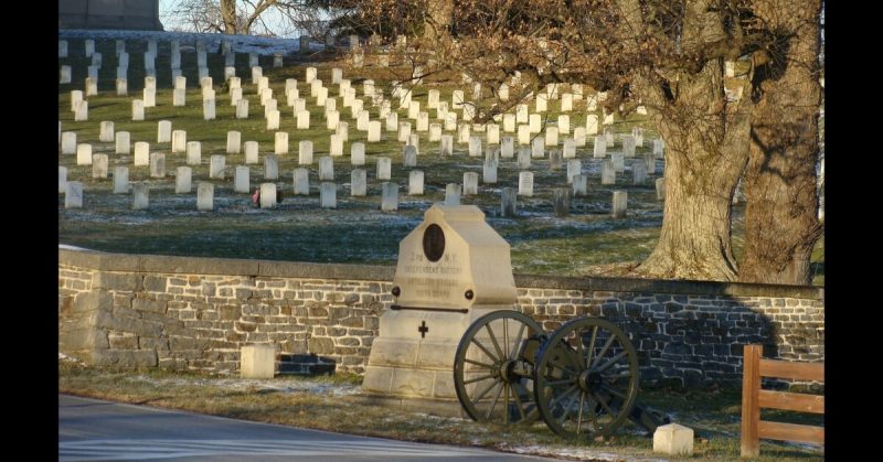 The Lincoln Address Memorial (top left) in the Gettysburg National Cemetery. The 2 small flanking markers for the 3rd NY Artillery monument (foreground) indicate the breadth of the unit's position. <a href=https://commons.wikimedia.org/wiki/File:Gettysburg5.JPG>Photo Credit</a>
