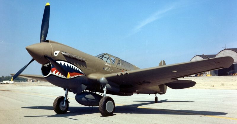 A Curtiss P-40E  with the distinctive shark paint up front. This is an American Plane, on Display in Dayton, Ohio. Wikipedia / Public Domain