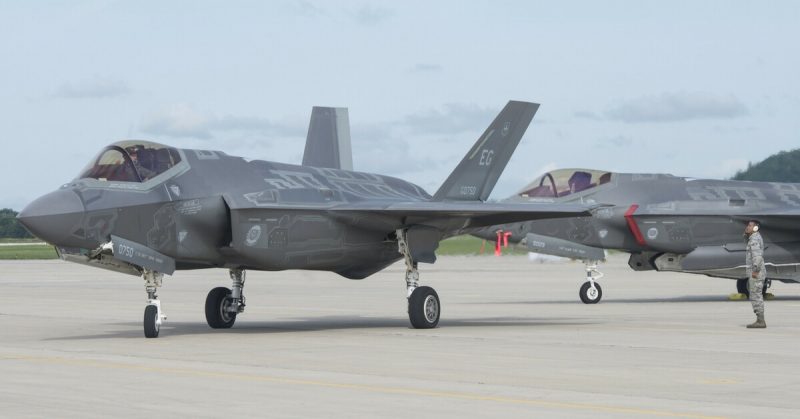 Senior Airman Kolby Burton, 33rd Aircraft Maintenance Squadron weapons load crew member, salutes Maj. Jeff Osborne, 33rd Fighter Wing F-35A pilot, during exercise Northern Lightning.