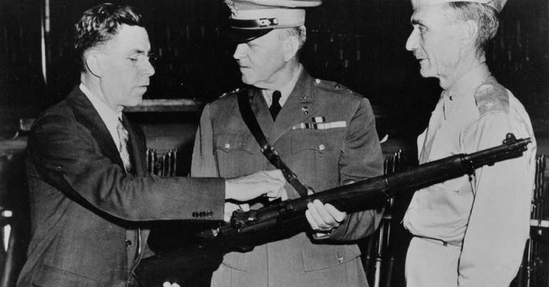 John Garand points out features of the M1 to army generals.