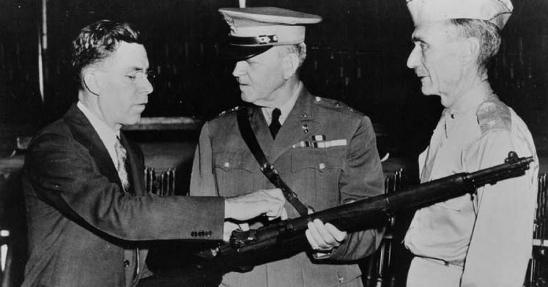 John Garand points out features of the M1 to army generals.