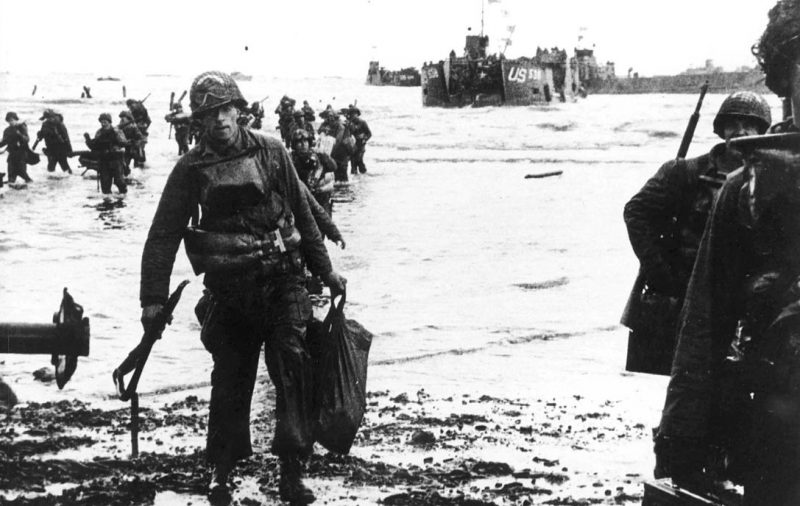 Carrying equipment, U.S. assault troops move onto Utah Beach.