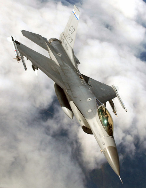 An F-16C of the Colorado Air National Guard with AIM-9 Sidewinder missiles, an Air Combat Maneuvering Instrumentation pod, and a centerline fuel tank.