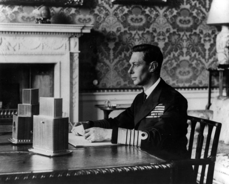 King George VI sitting at a table