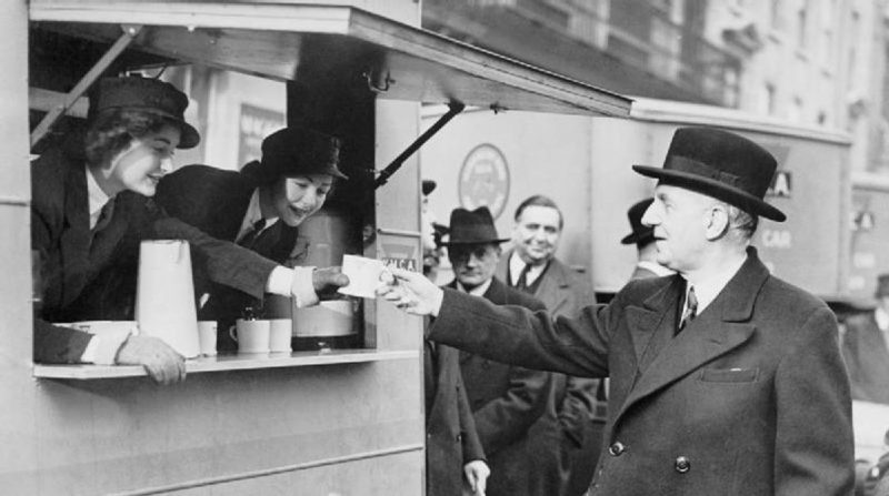 The British Minister for Food, Lord Woolton, receiving a cup of tea from a mobile canteen. 