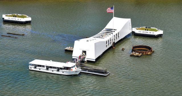 Tourists visit the Valor in the Pacific Monument.