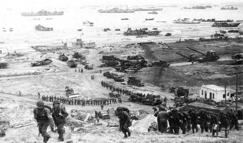 Omaha beach - Invasion of Normandy. Reinforcements of men and equipment moving inland.