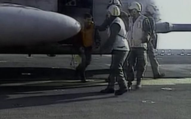 O'Grady (in the orange vest) stepping foot on the USS Kearsarge on July 8, 1995