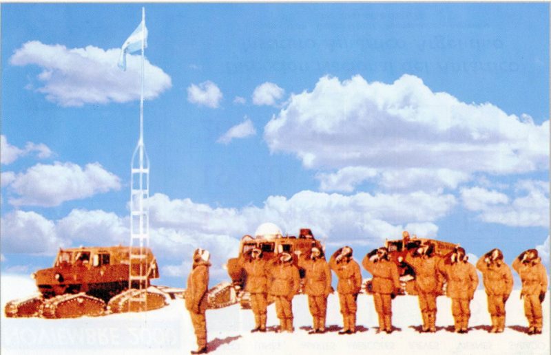 Soldiers saluting the flag at the South Pole.