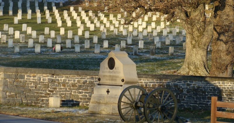 The Lincoln Address Memorial (top left) in the Gettysburg National Cemetery. The 2 small flanking markers for the 3rd NY Artillery monument (foreground) indicate the breadth of the unit's position. Sallicio - CC BY-SA 3.0