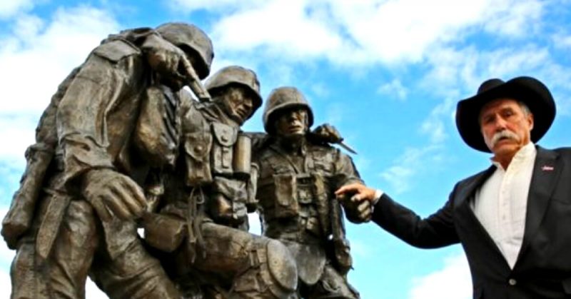 Sculptor John Phelps Poses with his Sculpture Based on the Iconic Photograph