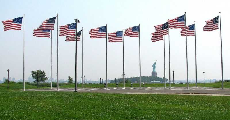 The Statue of Liberty can be seen past American flags at the site of the explosion. 