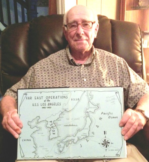Enlisting in the U.S. Navy in 1951, Vernon Walther served as a cook aboard the USS Los Angeles—a WWII heavy cruiser that was recommissioned during the Korean War. He is pictured with a cruise book highlighting the routes the ship sailed during the war. Courtesy of Jeremy P. Ämick.