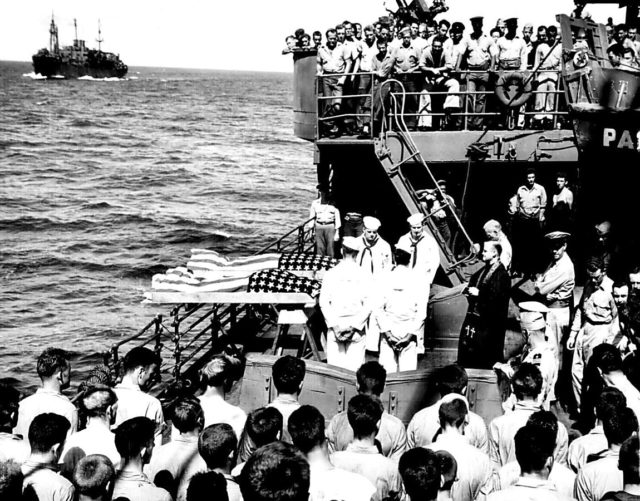 Two enlisted men of the ill-fated U.S. Navy aircraft carrier LISCOME BAY, torpedoed by a Japanese submarine in the Gilbert Islands, are buried at sea from the deck of a Coast Guard-manned assault transport. November 1943.