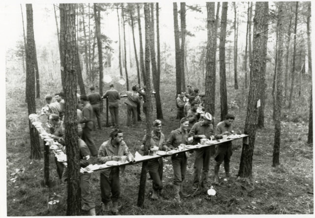 Soldiers from Headquarters, 44th Infantry Division, composed of elements from the New Jersey and New York National Guards, eat Thanksgiving dinner in the closing days of the Carolina Maneuvers, November 1941. NGB Historical Services Branch.