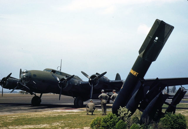 1938. A mighty B-17 bomber is pulled up at a bombardment squadron hangar, Langley Field, Va. It is all set to taxi out to a runway and take off.