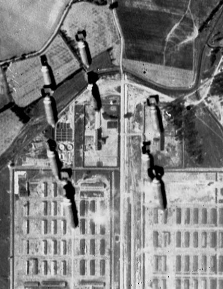 Bombs released 13 September 1944 just over the end of the Auschwitz-Birkenau camp. You can see crematoria 2 and 3, and a train on the ramp. Photo Credit: author’s collection.