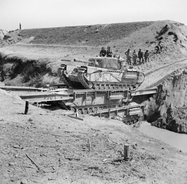 A Churchill tank of the North Irish Horse crossing the Senio in Italy on two stacked Churchill ARKs, April 1945. Photo Credit.