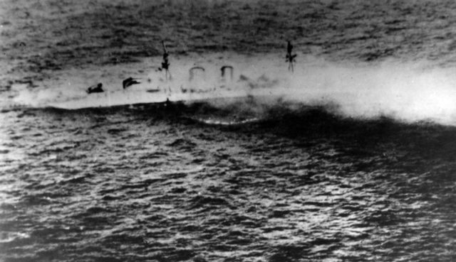 The Royal Navy heavy cruiser HMS Exeter sinking after the Battle of the Java Sea, 1 March 1942.
