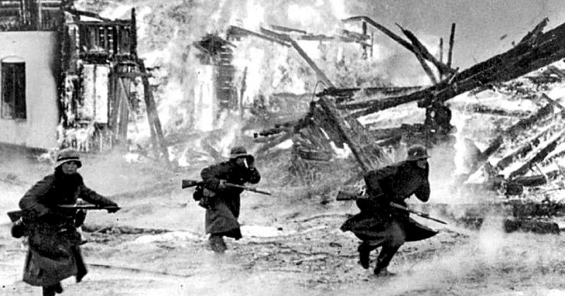 German Soldiers in a burning village in Norway, 1940. <a href=https://commons.wikimedia.org/wiki/Category:Images_from_the_German_Federal_Archive>Photo Credit</a>