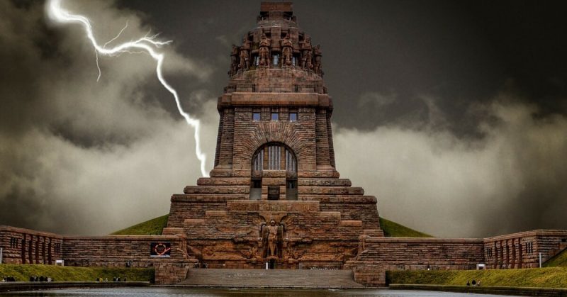 Lightning strikes behind the monument to the Battle of the Nations, Leipzig, Saxony, Germany. 