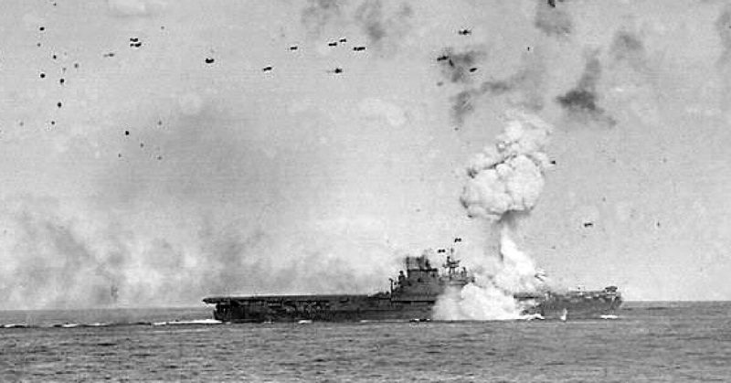 The U.S. Navy aircraft carrier USS Enterprise (CV-6) being hit by a Japanese bomb-laden kamikaze on 21 May 1945.
