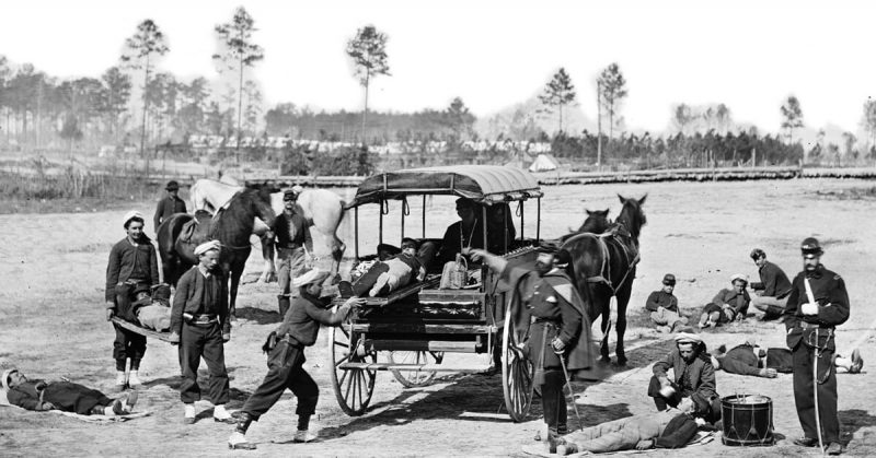 American Zouave ambulance crew demonstrating removal of wounded soldiers from the field, during the American Civil War.