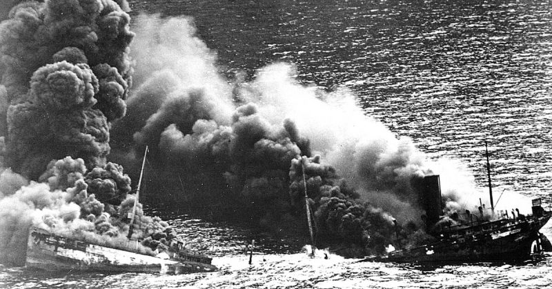 Allied tanker torpedoed in Atlantic Ocean by German submarine. Crumbling amidship under heat of fire, the ship settles toward  the seafloor, 1942.
