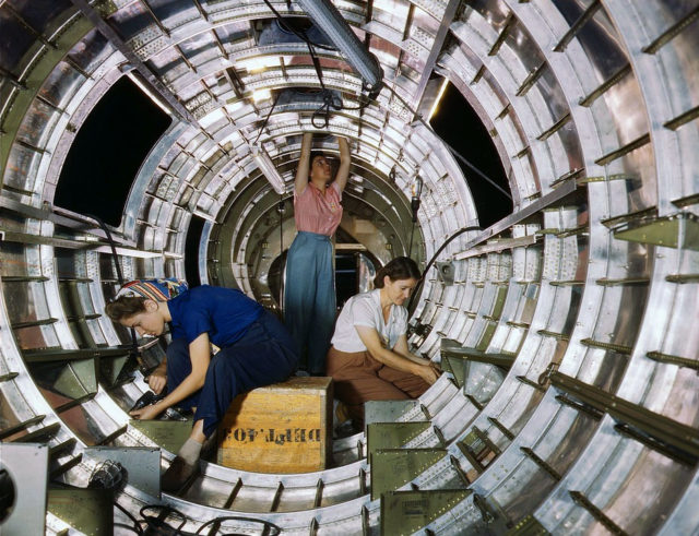 1938. Women workers install fixtures and assemblies to a tail fuselage section of a B-17F bomber at the Douglas Aircraft Company, Long Beach, Calif.