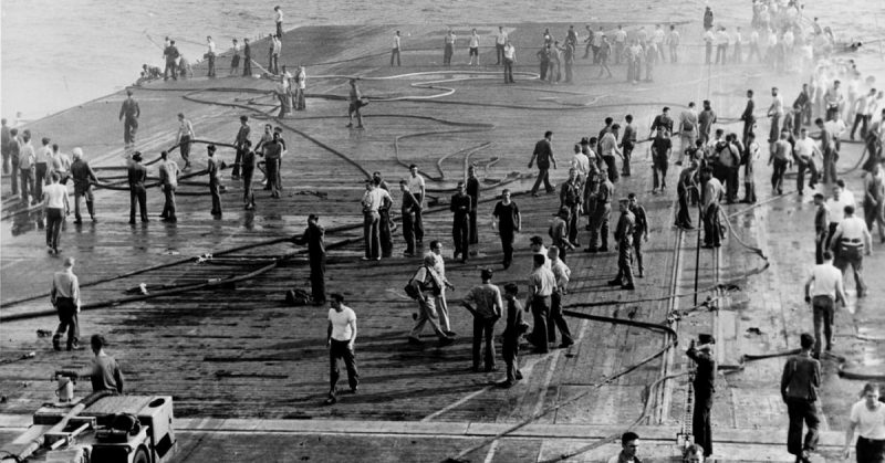 View of the forward flight deck of the U.S. Navy aircraft carrier USS Oriskany (CVA-34) during the fire on 26 October 1966 off Vietnam.