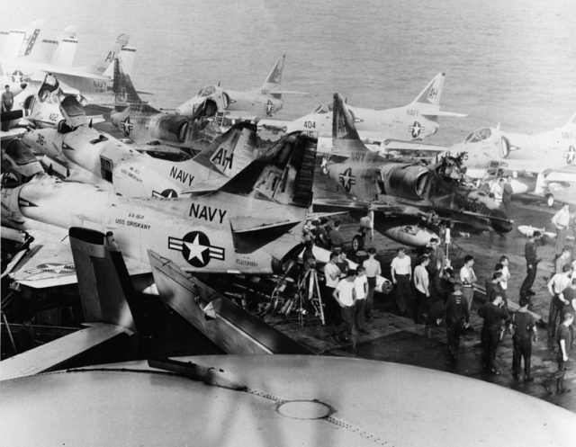 Damaged U.S. Navy Douglas A-4E Skyhawk fighters of Attack Carrier Air Wing 16 (CVW-16) on the flight deck of the aircraft carrier USS Oriskany (CVA-34) off Vietnam on 26 October 1966.