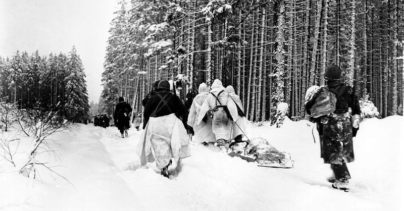 Battle of the bulge - American troops drag a heavily loaded ammunition sled through the snow, as they move for an attack on Herresbach, Belgium. 