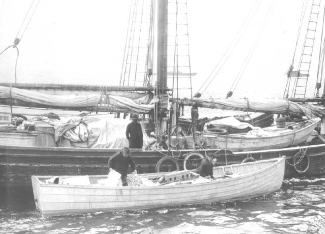 A Coast Guard vessel apprehends a sailing ship which intended to sell illicit alcohol in the United States during prohibition.