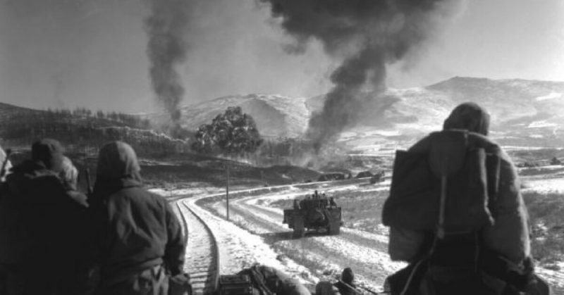 American troops watch airstrikes in the Korean war.