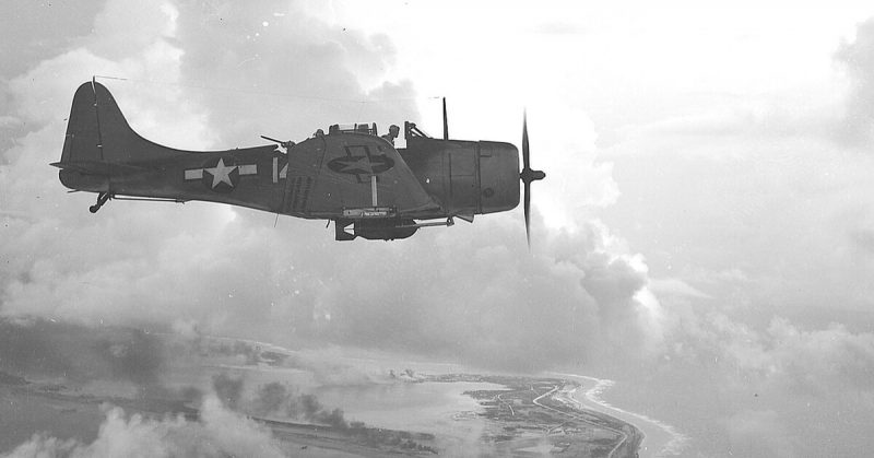A U.S. Navy Douglas SBD-5 Dauntless dive bomber over Wake Island, 1943.
