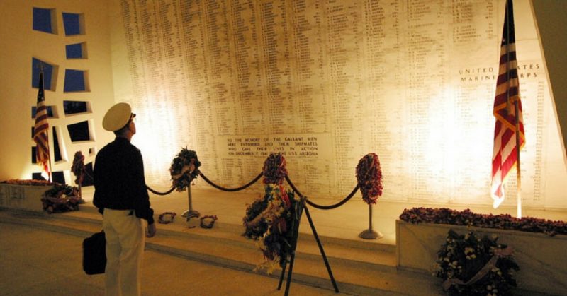 A Veteran gazes at the names of the Honored Dead inscribed at the USS Arizona Memorial at Pearl Harbor. 